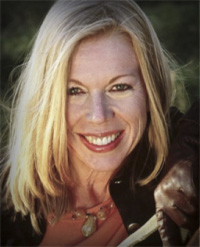 Smiling woman with blonde hair outdoors.